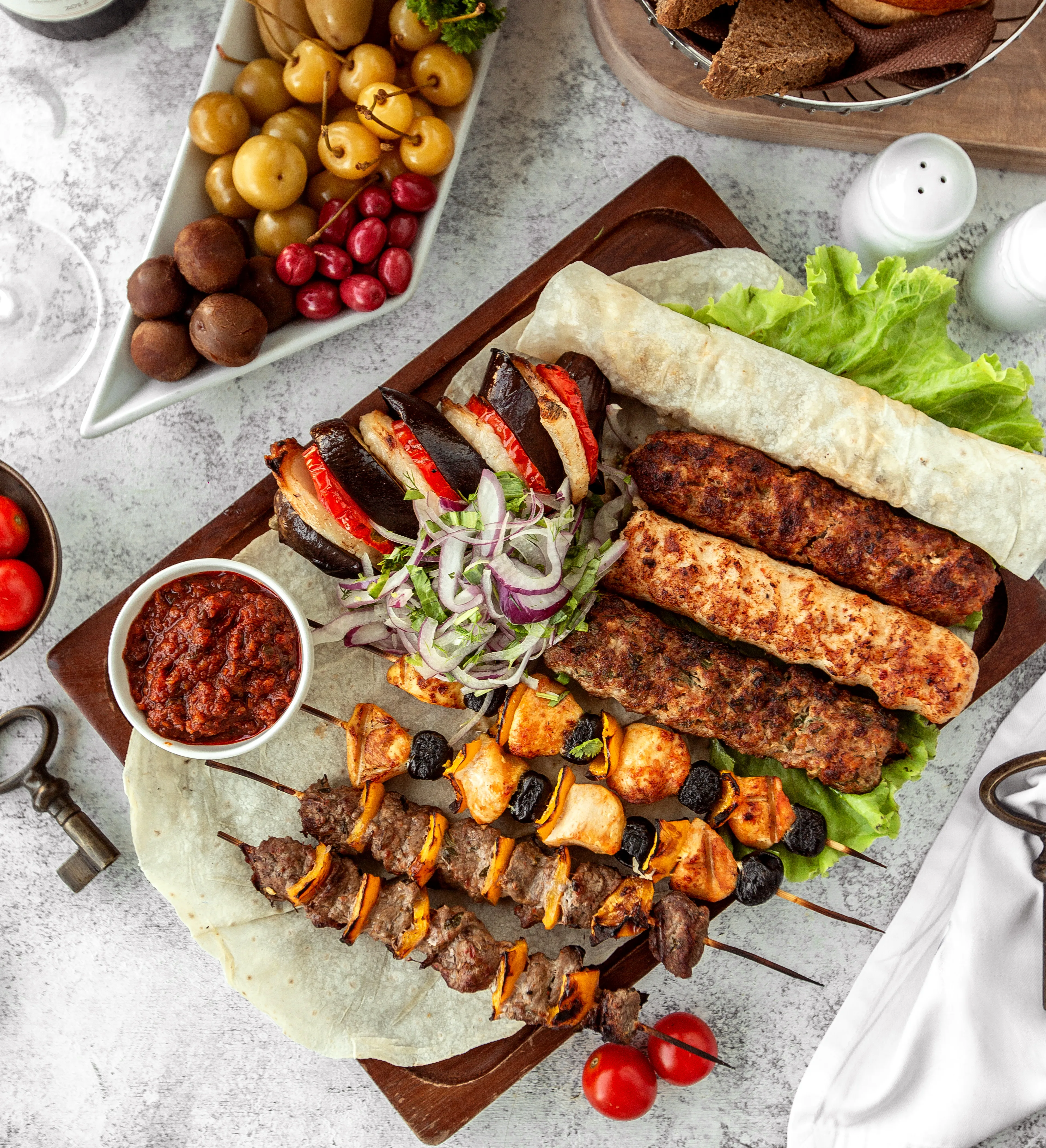 Top view kebab platter with skewers and salad